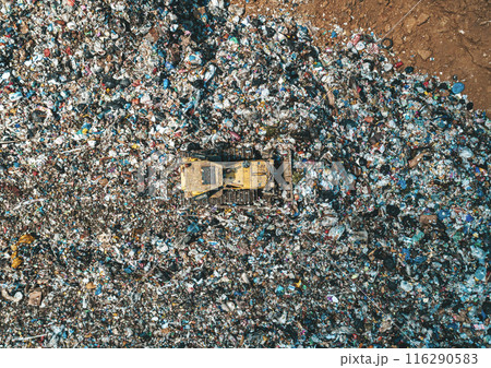 Aerial top down view of bulldozer working in a large landfill 116290583