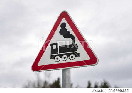 Train Crossing Sign with Vintage Locomotive illustrates caution and transportation safety Train Crossing Sign with Vintage Locomotive illustrates caution and transportation safety 116290886