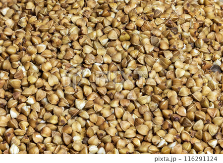 Close-up of buckwheat seeds in full frame. Seeds of buckwheat groats in the whole frame close up 116291124