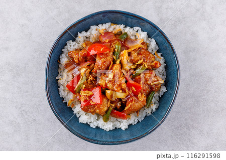 Rice with pork and vegetables in a sweet and sour sauce on a grey background, for a restaurant menu or food delivery 116291598