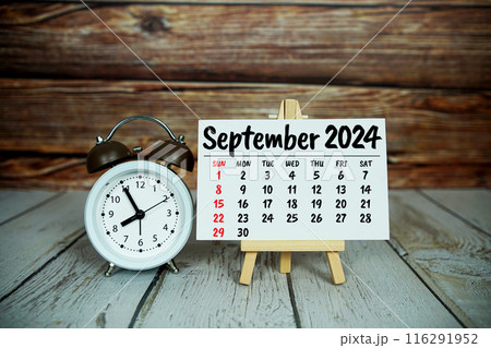 SEPTEMBER 2024 monthly calendar for planning and management concept with alarm clock on wooden background 116291952