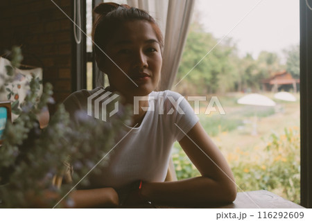 Woman in white t-shirt waiting for someone at the table of the restaurant. Woman in white t-shirt waiting for someone at the table of the restaurant. 116292609