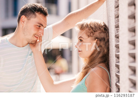 Man flirting with girl on city street 116293187