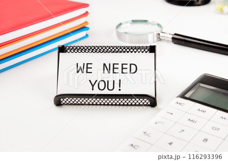 Concept words We need you Business and We need you concept. We need you symbol on a business card in a stand on a white background Concept words We need you Business and We need you concept. We need you symbol on a business card in a stand on a white background 116293396