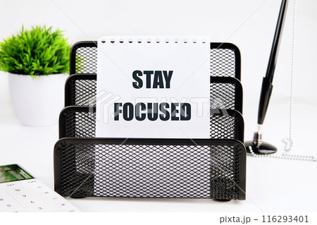 STAY FOCUSED written on a piece of paper on a white background STAY FOCUSED written on a piece of paper on a white background 116293401