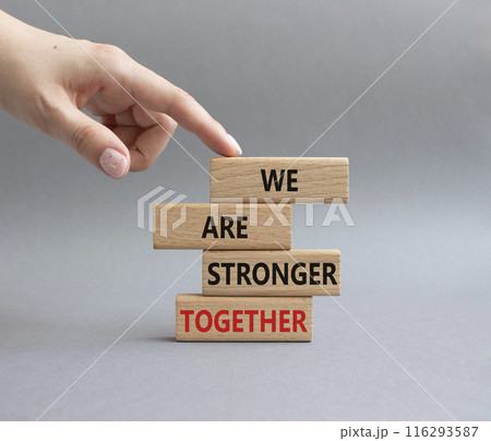 We are stronger together symbol. Wooden blocks with words We are stronger together. Businessman hand. Beautiful grey background. We are stronger together concept. Copy space. We are stronger together symbol. Wooden blocks with words We are stronger together. Businessman hand. Beautiful grey background. We are stronger together concept. Copy space. 116293587