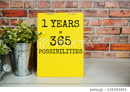 1 Years 365 Possibilities text message with alarm clock on wooden background, Inspriation and motivationa quote 1 Years 365 Possibilities text message with alarm clock on wooden background, Inspriation and motivationa quote 116293943