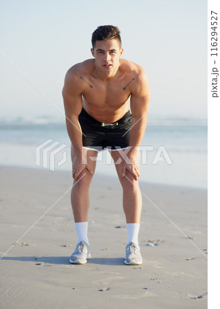 Man, tired and beach fitness with portrait, exercise and runner training with fatigue by the sea. Outdoor, breathing and athlete with health, wellness and sport in nature by ocean with running break Man, tired and beach fitness with portrait, exercise and runner training with fatigue by the sea. Outdoor, breathing and athlete with health, wellness and sport in nature by ocean with running break 116294527