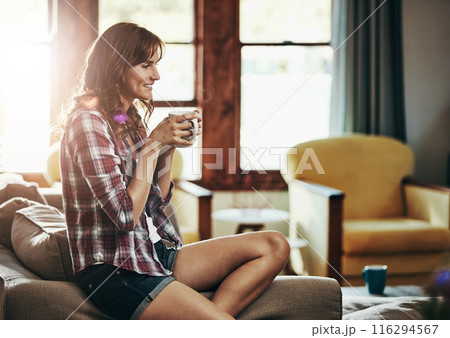 Coffee, relax and thinking with woman on sofa in living room of home for morning or weekend time off. Drink, happy or smile and person in apartment with fresh caffeine beverage for break or wellness Coffee, relax and thinking with woman on sofa in living room of home for morning or weekend time off. Drink, happy or smile and person in apartment with fresh caffeine beverage for break or wellness 116294567