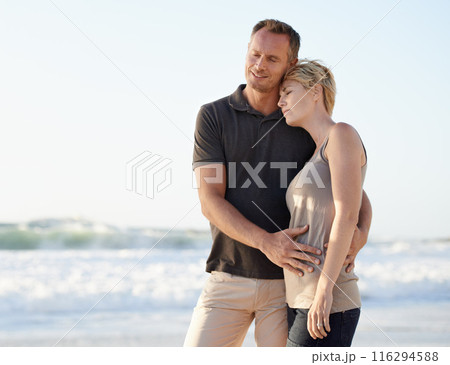 Couple, love and happy on beach with hug for bonding, honeymoon date or weekend holiday in Maldives. Man, woman and embrace with smile or care by water at sea for vacation, travel and adventure 116294588