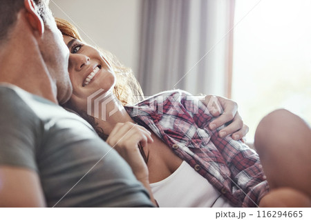 Couple, smile and relax on sofa with hug at home for support, bonding and care on weekend. Happy, peace and man with affection to woman in living room for commitment, comfort and romance in marriage Couple, smile and relax on sofa with hug at home for support, bonding and care on weekend. Happy, peace and man with affection to woman in living room for commitment, comfort and romance in marriage 116294665