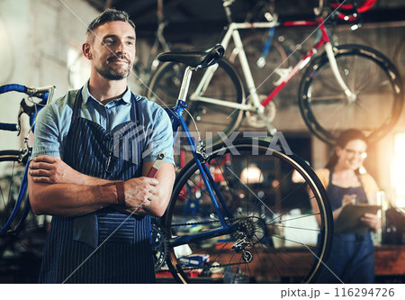 Man, bicycle mechanic and professional with confidence in small business for fix, repair or maintenance. Confident male person, cycle technician or bike engineer with tool or equipment at workshop Man, bicycle mechanic and professional with confidence in small business for fix, repair or maintenance. Confident male person, cycle technician or bike engineer with tool or equipment at workshop 116294726