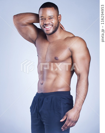 Black man, portrait and shirtless abs in studio, strong stomach and muscle on blue background. Male person, confidence and athlete for power or healthy body, bodybuilder and topless for fitness Black man, portrait and shirtless abs in studio, strong stomach and muscle on blue background. Male person, confidence and athlete for power or healthy body, bodybuilder and topless for fitness 116294953