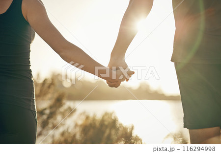 Couple, fitness and holding hands with sunset in nature for workout, exercise or outdoor training together. Closeup of active man and woman with support, care or love for health and wellness outside Couple, fitness and holding hands with sunset in nature for workout, exercise or outdoor training together. Closeup of active man and woman with support, care or love for health and wellness outside 116294998