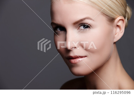 Woman, portrait and cosmetic glow in studio, makeup and skincare on gray background. Female person, beauty and proud of dermatology foundation results, wellness and facial treatment or mockup space 116295096