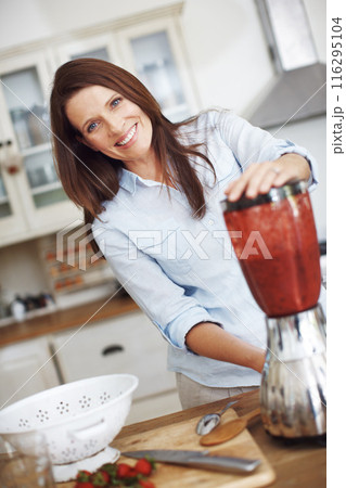 Woman, portrait and blender in kitchen for smoothie or shake, home and fresh recipe for breakfast detox diet. Girl, strawberry and happy for meal alternative, vitamin boost and natural nutrition. 116295104