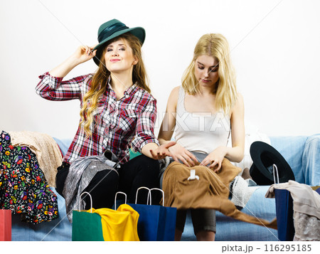 Two happy female friends after shopping 116295185