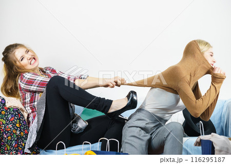 Two women arguing over sweater 116295187