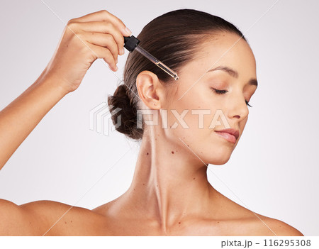 Woman, dropper and beauty with serum for skincare results, natural glow and application for skin health in studio. Model girl, dermatology and facial oil for cosmetics or collagen by white background 116295308