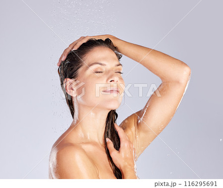 Shower, hair care and woman in studio with eyes closed for shampoo, water or hygiene on white background. Clean, body and female model washing for natural treatment, wellness or morning routine 116295691