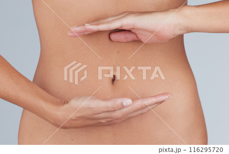 Woman, hands and belly for detox in studio, digestion and gut health or body care on blue background. Female person, lose weight and colon balance or stomach for diet, wellness and liposuction tummy Woman, hands and belly for detox in studio, digestion and gut health or body care on blue background. Female person, lose weight and colon balance or stomach for diet, wellness and liposuction tummy 116295720