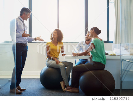 Creative, team and business people with leader for training, coaching or brainstorming in startup office. Group, planning and discussion for strategy, project and editor on fitness ball for exercise 116295753