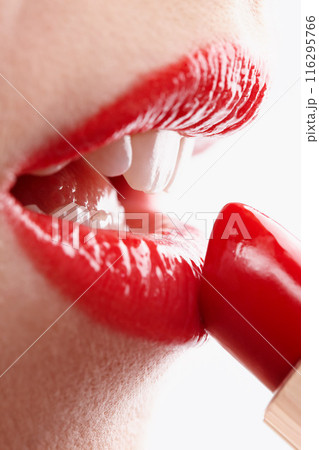 Woman, beauty and red for lipstick in studio, makeup and cosmetics for care on white background. Female person, salon and skincare in closeup, grooming and application in makeover or skin treatment 116295766
