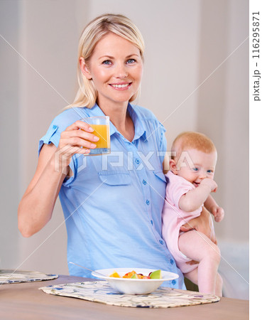 Woman, baby and happy with house, portrait and breakfast with fruit, orange juice and smile. Mother, daughter and food for health, wellness and home with morning, girl and kitchen for rest or eating 116295871