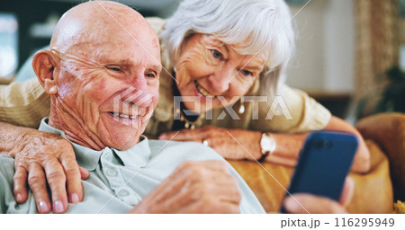 Senior couple, phone and reading on couch with hug, choice and click with video, download or search in home. Elderly woman, man and smartphone on lounge sofa with discussion for post on social media Senior couple, phone and reading on couch with hug, choice and click with video, download or search in home. Elderly woman, man and smartphone on lounge sofa with discussion for post on social media 116295949