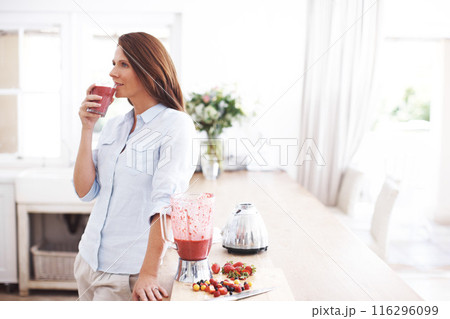 Woman, drink and glass in kitchen for smoothie or milkshake, handmade and fresh recipe for breakfast detox diet. Girl, strawberry and ideas for meal alternative, vitamin boost and natural nutrition. 116296099