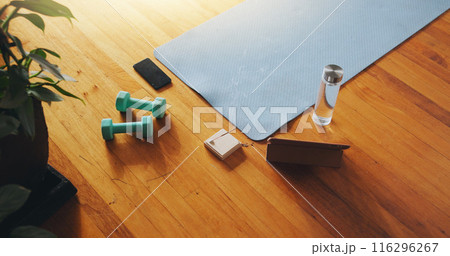 Gym, equipment and tablet with water on wooden floor for cardio, training and exercise in morning. Top view, incense and phone with h2o liquid in bottle for online streaming, hydration and music Gym, equipment and tablet with water on wooden floor for cardio, training and exercise in morning. Top view, incense and phone with h2o liquid in bottle for online streaming, hydration and music 116296267