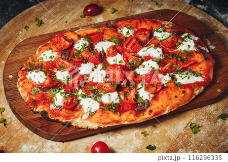 Tempting Margherita Pizza on Rustic Wooden Board 116296335