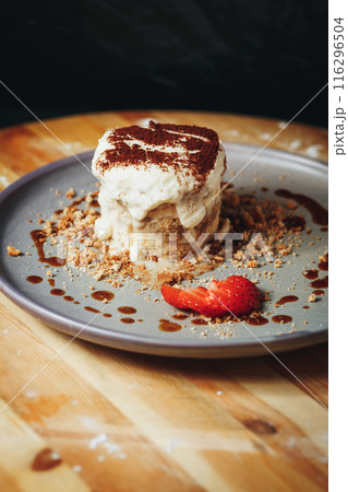 Delectable Tiramisu Served on a Ceramic Plate Garnished With Strawberry and Cocoa Delectable Tiramisu Served on a Ceramic Plate Garnished With Strawberry and Cocoa 116296504