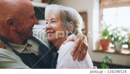 Senior couple, hug and happy in kitchen with love, support and bonding for health, wellness and nutrition. Elderly man and woman embrace for cooking and marriage at home for romance or anniversary 116296526