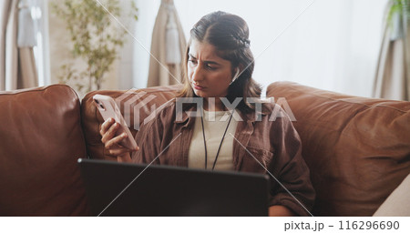 Thinking, woman and phone notification on sofa for entertainment, communication or internet browsing in home. Female person, thoughtful or concerned with laptop on couch for streaming or social media 116296690