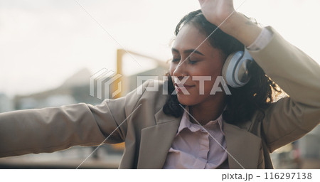 Happy person, headphones and dancing in city with music on app for online streaming in outdoor for celebration. Career woman, technology and cheerful for promotion, achievement or success in England Happy person, headphones and dancing in city with music on app for online streaming in outdoor for celebration. Career woman, technology and cheerful for promotion, achievement or success in England 116297138