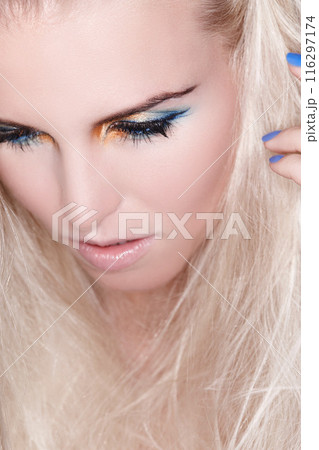 Face, woman and makeup with color eye shadow for cosmetics, skincare and thinking. Creative lashes, eyes and female person with shine for luxury, results and aesthetic for beauty and glowing 116297174