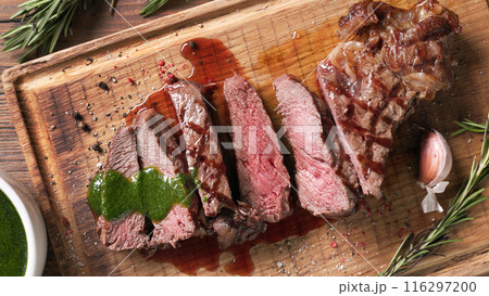 freshly grilled sliced steak with green parsley sauce freshly grilled sliced steak with green parsley sauce 116297200