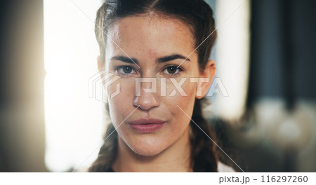 Woman, portrait and serious for training as athlete in fitness center for challenge in sports or wellness. Female person, strong and ready with healthy for performance in mma, boxing match or fight 116297260