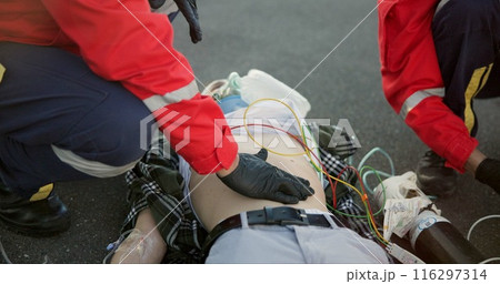Healthcare, outdoor and paramedic with patient, helping and hand on stomach, check and oxygen mask. Street, teamwork and rescue of person, EMS and palpate of abdomen, accident and first responder 116297314