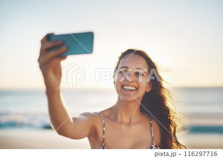 Woman, sunset and happy for selfie at beach, adventure and memory with photography on vacation. Girl, person or influencer for live streaming, smile or photography for profile picture by sea on app Woman, sunset and happy for selfie at beach, adventure and memory with photography on vacation. Girl, person or influencer for live streaming, smile or photography for profile picture by sea on app 116297716