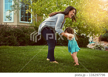 Mother, child and happy with playing in garden for fun activity, bonding and smile outdoor in home. Family, woman and daughter on grass of house with care, explore and healthy relationship in nature 116297796