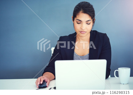 Laptop, copywriter and woman in working, reading on internet at office with serious for research. Creative, person and technology in online, digital and website for deadline, due date or project 116298315