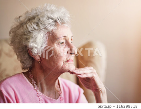 Window, elderly or woman thinking in nursing house with memory, ideas or calm peace on living room. Daydreaming, remember and senior lady with decision and nostalgia in retirement, lounge or home Window, elderly or woman thinking in nursing house with memory, ideas or calm peace on living room. Daydreaming, remember and senior lady with decision and nostalgia in retirement, lounge or home 116298518