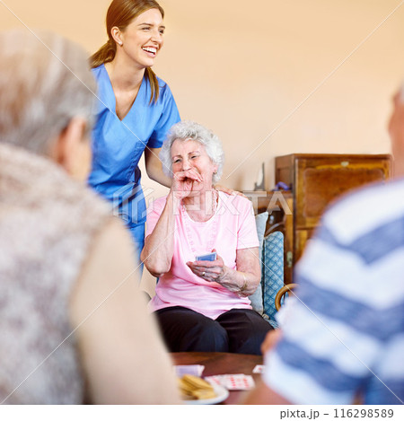 Women, nurse and laughing patient with playing cards for games, fun and happy at nursing home. People, caregiver and smile with bonding for care, support and trust in healthcare for entertainment 116298589