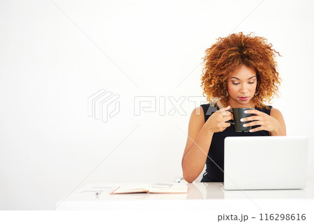 Woman, laptop and coffee in studio by space for mock up with thinking by white background. African person, computer and drink in tea cup with reading, research and notebook for job at creative agency 116298616
