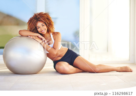 Girl, smile and portrait in home with medicine ball for exercise, workout and satisfied with progress. Female person, break and happy or confident with fitness for health, wellbeing and wellness Girl, smile and portrait in home with medicine ball for exercise, workout and satisfied with progress. Female person, break and happy or confident with fitness for health, wellbeing and wellness 116298617