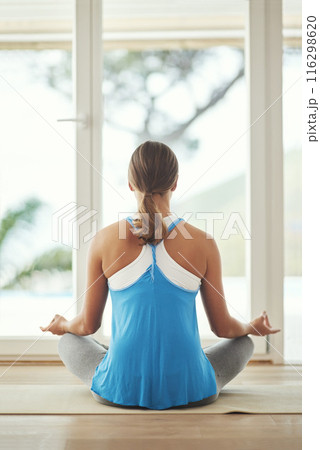 Yoga, lotus meditation and woman back in home for health, wellness and mindfulness exercise. Pilates, zen chakra and calm yogi for spiritual training, holistic workout or peace in living room 116298620