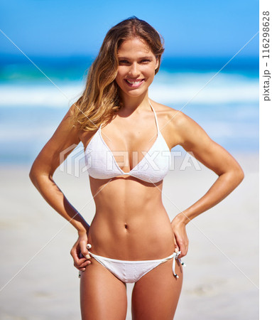 Confident, woman and portrait in bikini on beach for adventure, holiday or sunshine at tropical resort in Maldives. Female person, body and travel on vacation, peace or blue sky by ocean waves Confident, woman and portrait in bikini on beach for adventure, holiday or sunshine at tropical resort in Maldives. Female person, body and travel on vacation, peace or blue sky by ocean waves 116298628