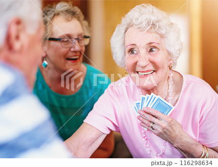 Assisted living, senior woman and poker with friends playing cards in retirement home together. Community, competition or game with happy elderly people in apartment for bonding, fun or leisure 116298634